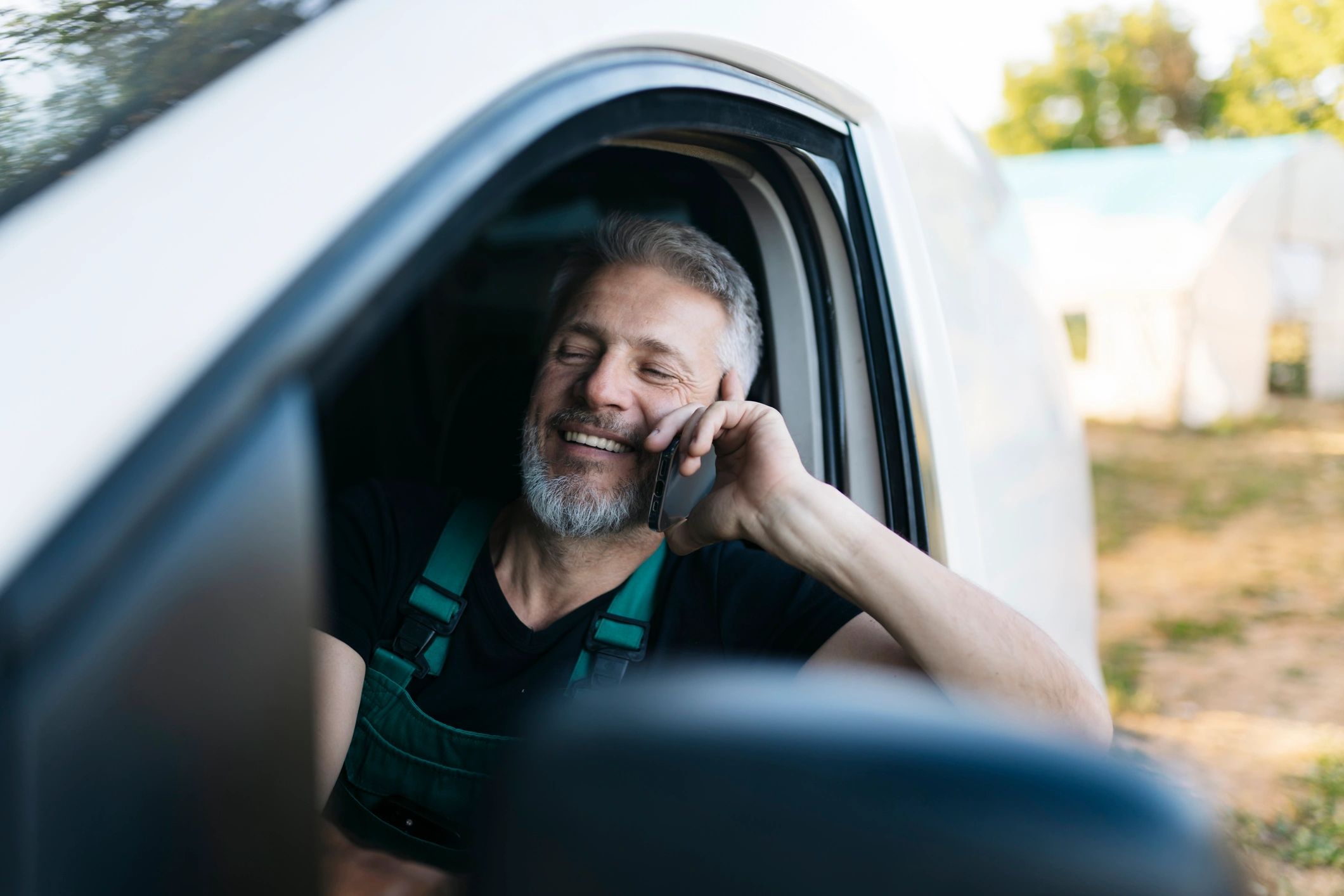 Electrician on the phone in a service van